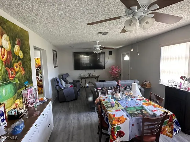 a view of a dining room with furniture and a flat screen tv