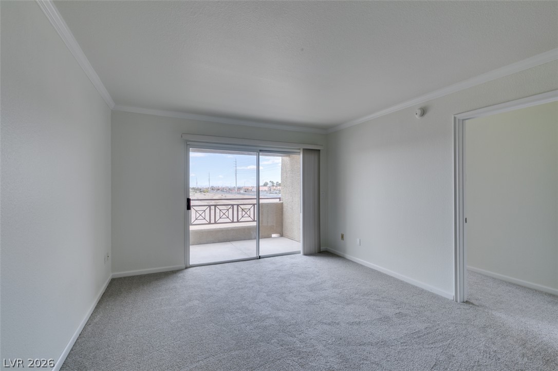 8070 West Russell Road, Unit 2026 Las Vegas, NV 89113 - Photo 17 of 41 Bright interior space featuring a sliding glass door opening to a private balcony.