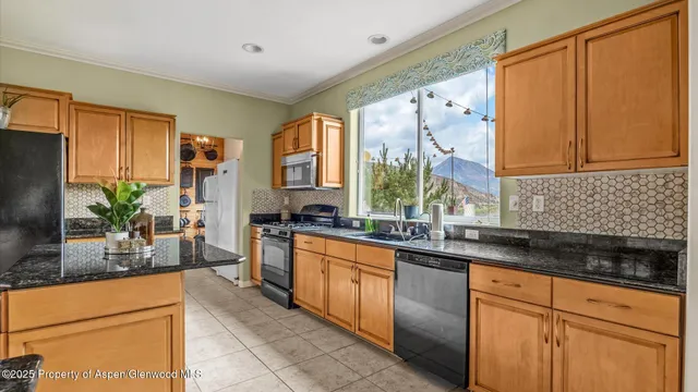 a kitchen with stainless steel appliances granite countertop sink stove and cabinets