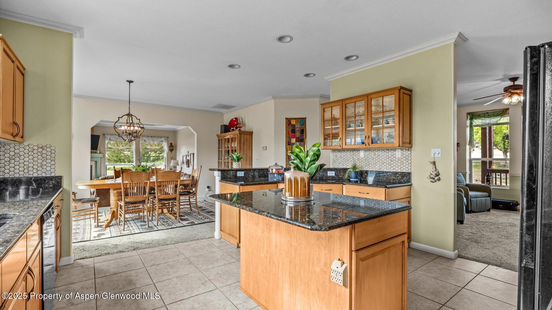 40380 D Road Crawford, CO 81415 - Photo 18 of 52 a dining table with chairs and a chandelier