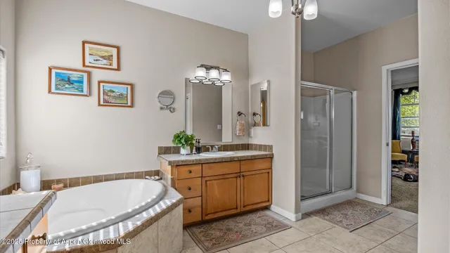 a bathroom with a tub sink and mirror
