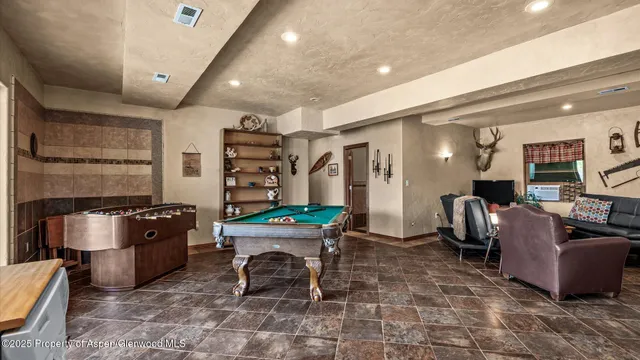 a kitchen with refrigerator and cabinets