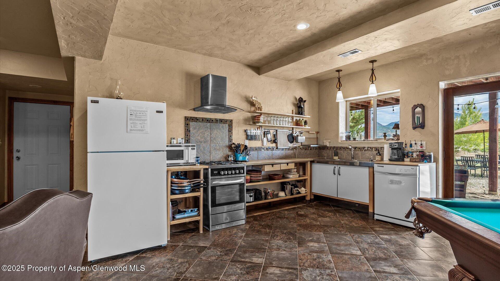 40380 D Road Crawford, CO 81415 - Photo 41 of 52 a kitchen with refrigerator and cabinets