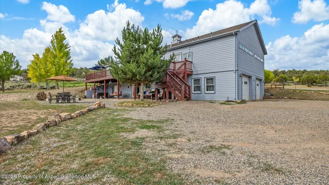 a view of a house with a yard porch and sitting area