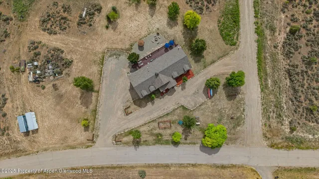 an aerial view of a house with a yard