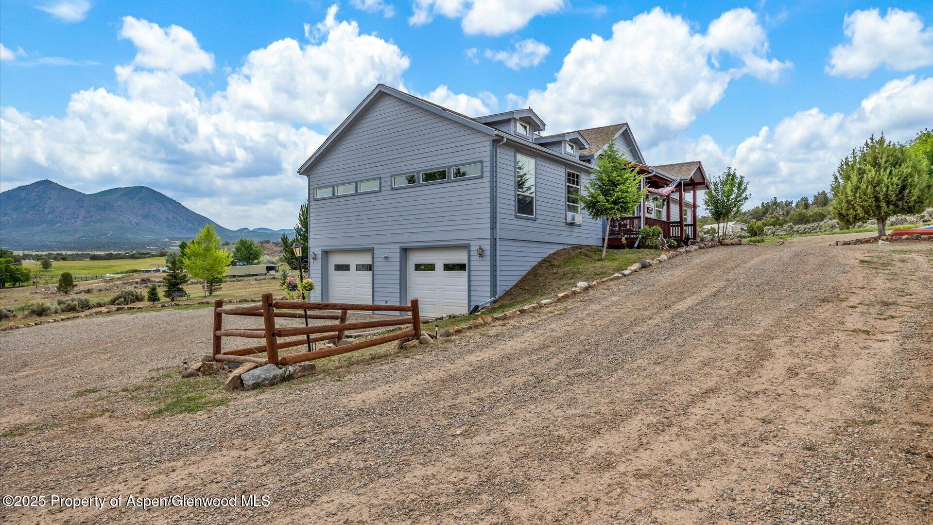40380 D Road Crawford, CO 81415 - Photo 6 of 52 a view of a house with a yard and table and chairs