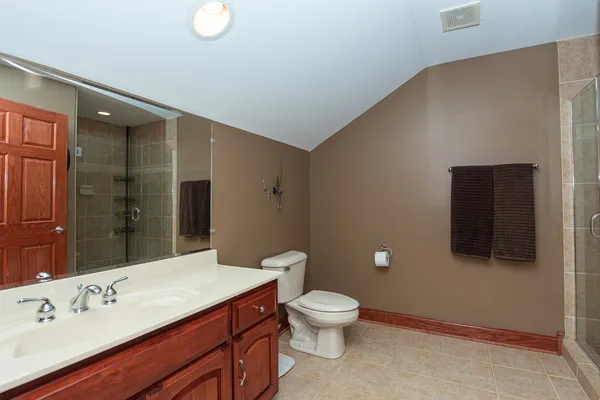 a kitchen with stainless steel appliances granite countertop a sink a stove and a refrigerator