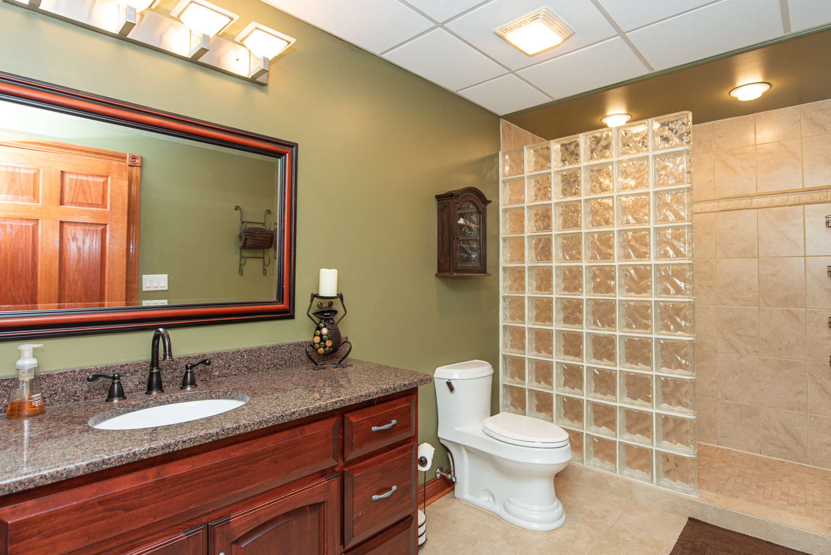 19657 West Sharp Road Elwood, IL 60421 - Photo 33 of 64 a bathroom with a granite countertop toilet a sink and a mirror
