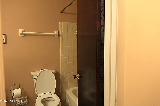 a bathroom with a granite countertop shower