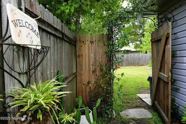 a view of a chair and table in backyard of the house