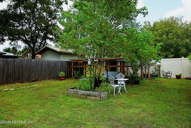 a view of a table and chairs in the garden