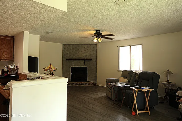 a view of a workspace with furniture and a fireplace