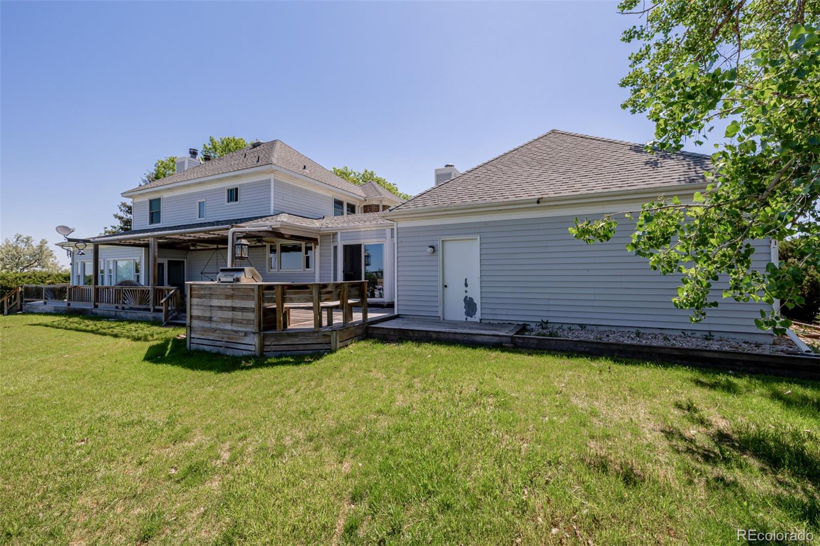 14447 Madison Street Thornton, CO 80602 - Photo 14 of 37 a aerial view of a house with a garden and deck
