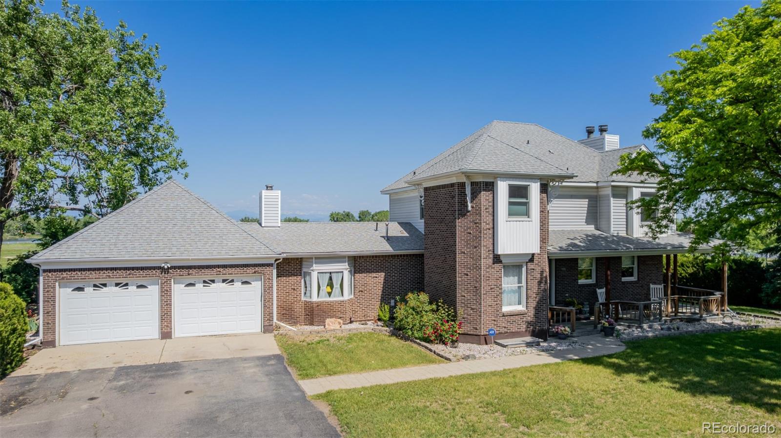14447 Madison Street Thornton, CO 80602 - Photo 15 of 37 a front view of a house with a yard and porch