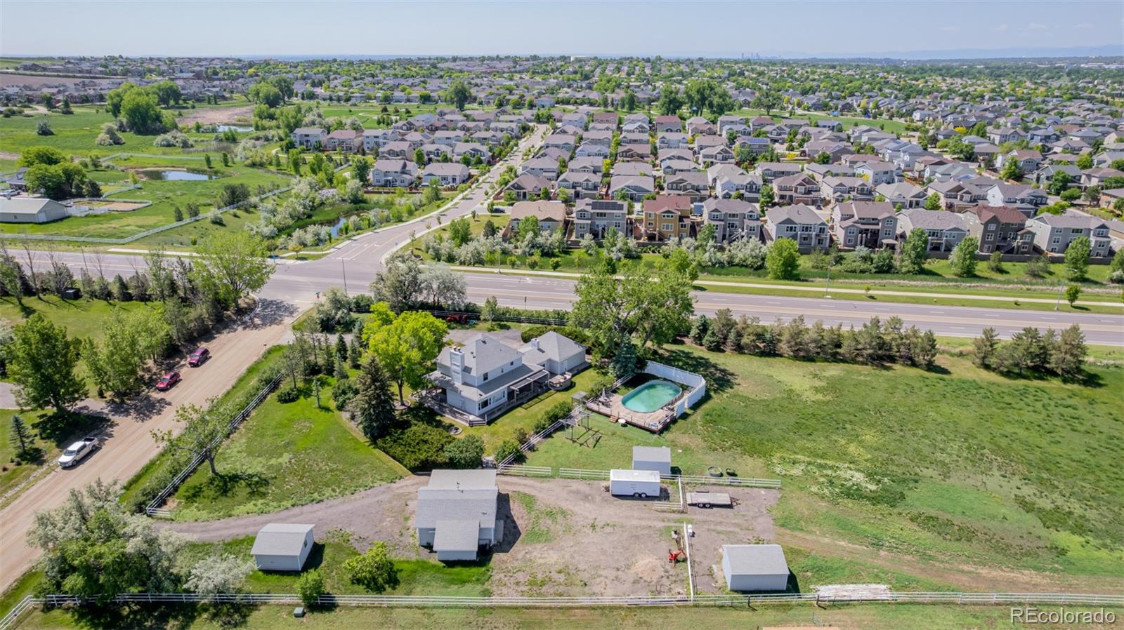 14447 Madison Street Thornton, CO 80602 - Photo 16 of 37 an aerial view of a house with a garden and lake view