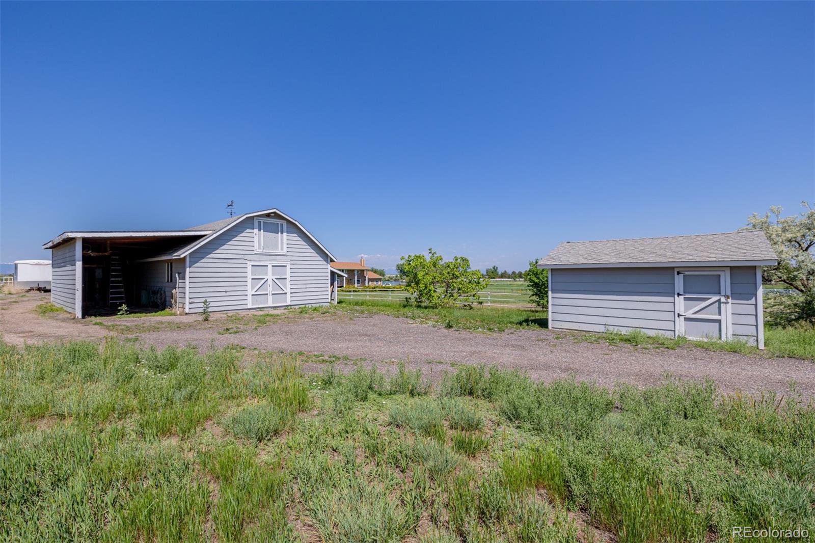 14447 Madison Street Thornton, CO 80602 - Photo 17 of 37 a front view of a house with garden