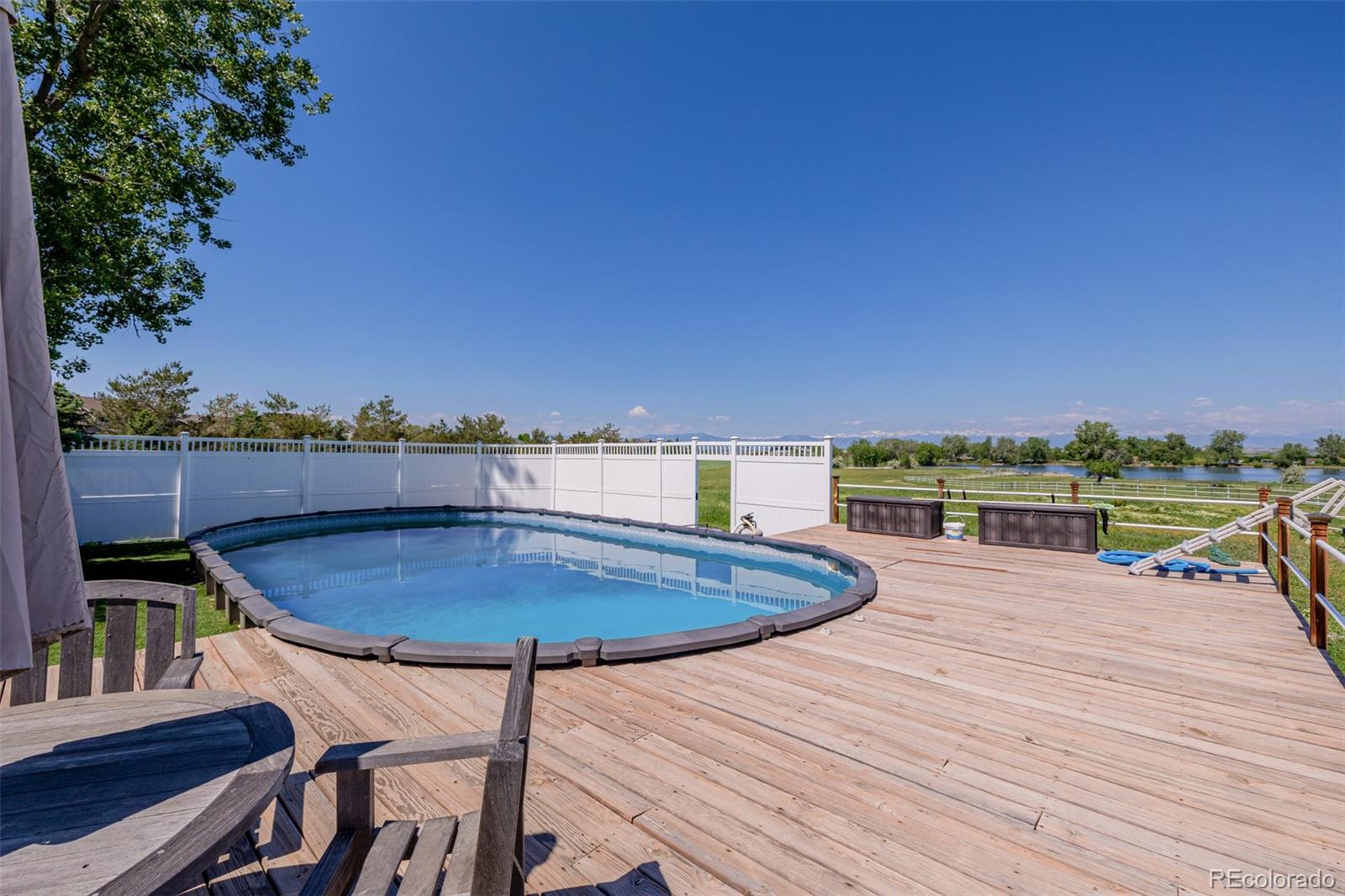 14447 Madison Street Thornton, CO 80602 - Photo 21 of 37 a view of a swimming pool with a lounge chair