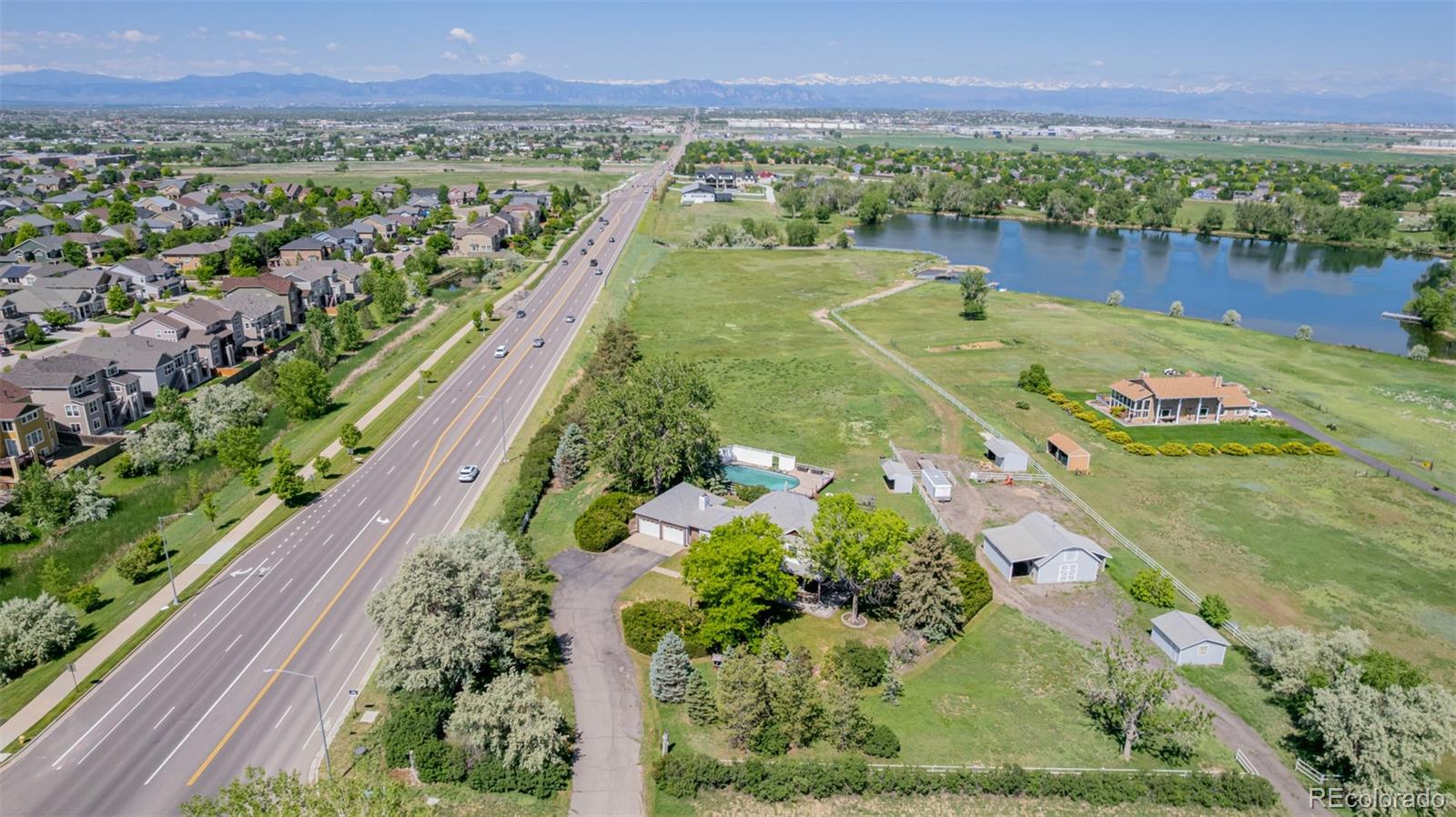 14447 Madison Street Thornton, CO 80602 - Photo 23 of 37 an aerial view of lake residential house with swimming pool and green space