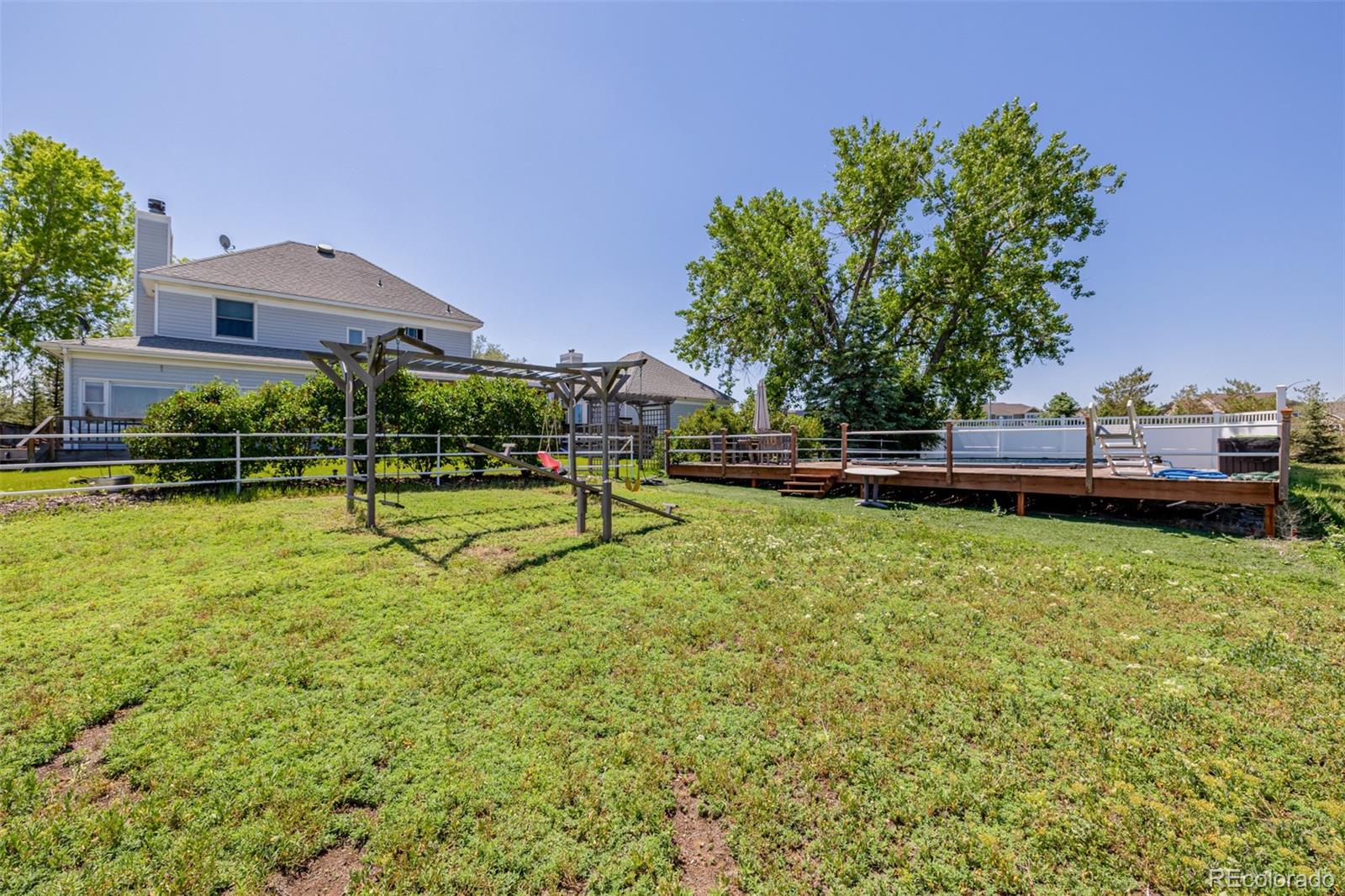 14447 Madison Street Thornton, CO 80602 - Photo 26 of 37 a view of a garden with a house in the background