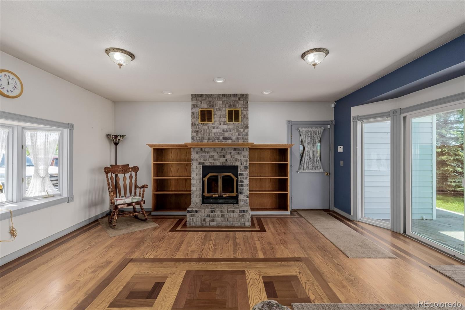 14447 Madison Street Thornton, CO 80602 - Photo 28 of 37 a living room with furniture and a fireplace