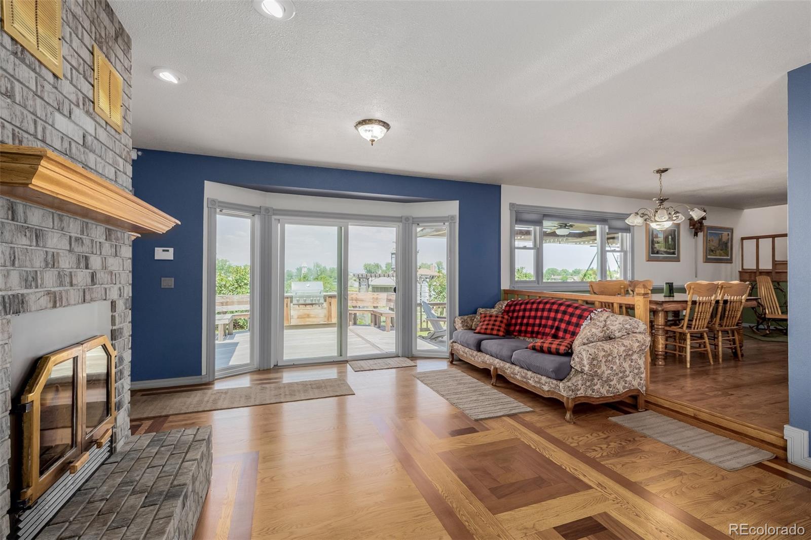 14447 Madison Street Thornton, CO 80602 - Photo 29 of 37 a spacious bedroom with a balcony a bed and a couch