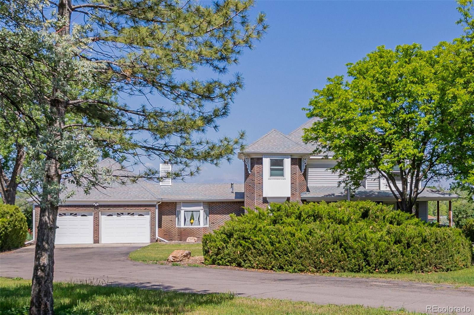 14447 Madison Street Thornton, CO 80602 - Photo 3 of 37 front view of a house with a tree