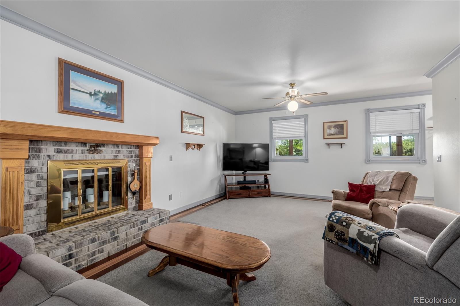 14447 Madison Street Thornton, CO 80602 - Photo 35 of 37 a living room with furniture and a fireplace