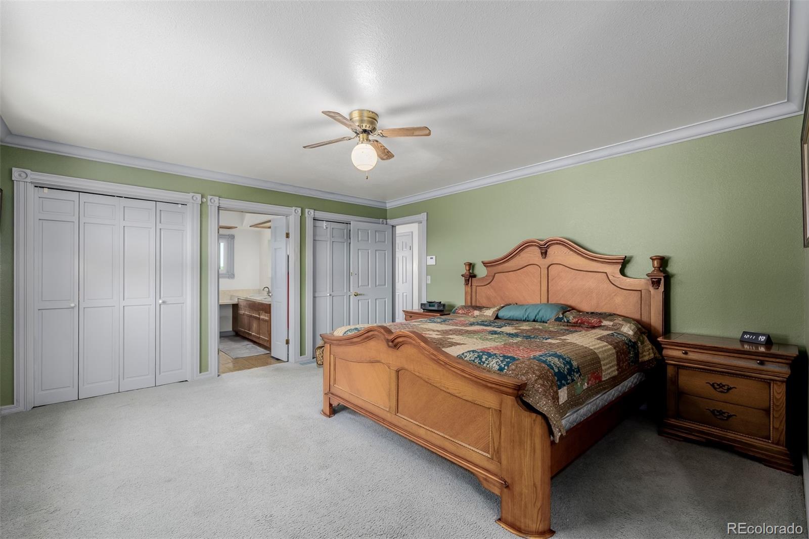 14447 Madison Street Thornton, CO 80602 - Photo 36 of 37 a bedroom with a bed and a chandelier