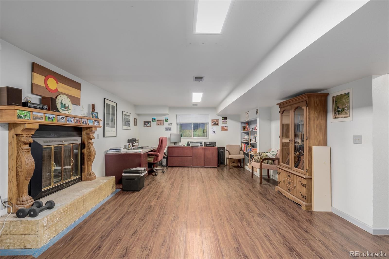 14447 Madison Street Thornton, CO 80602 - Photo 37 of 37 a living room with furniture flat screen tv and fireplace