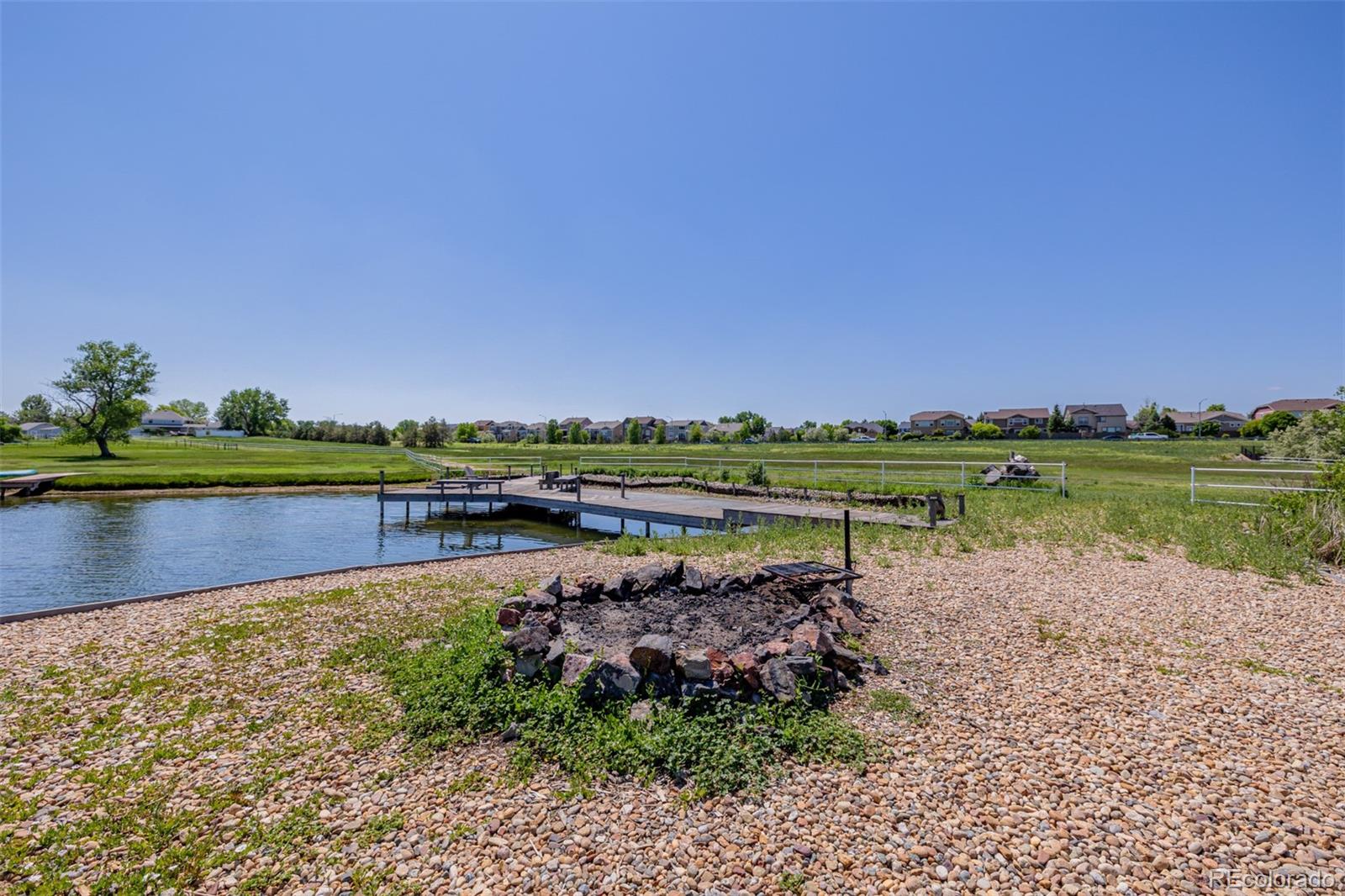 14447 Madison Street Thornton, CO 80602 - Photo 6 of 37 a view of a lake with houses in the back
