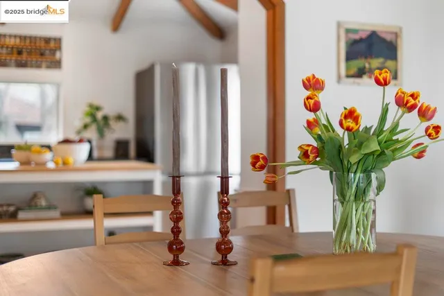 a vase of flowers sitting on a table with a potted plant