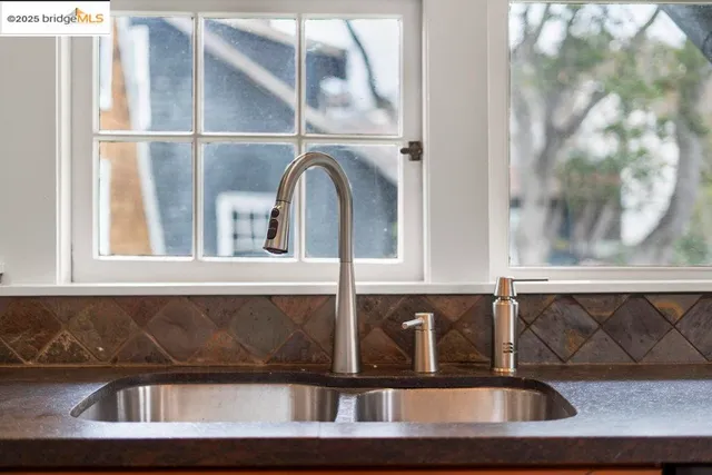 a kitchen with stainless steel appliances granite countertop a sink stove and cabinets