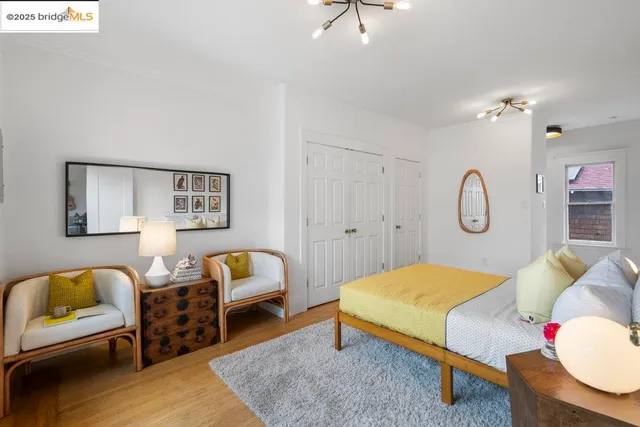 a bedroom with a bed a chandelier and a window