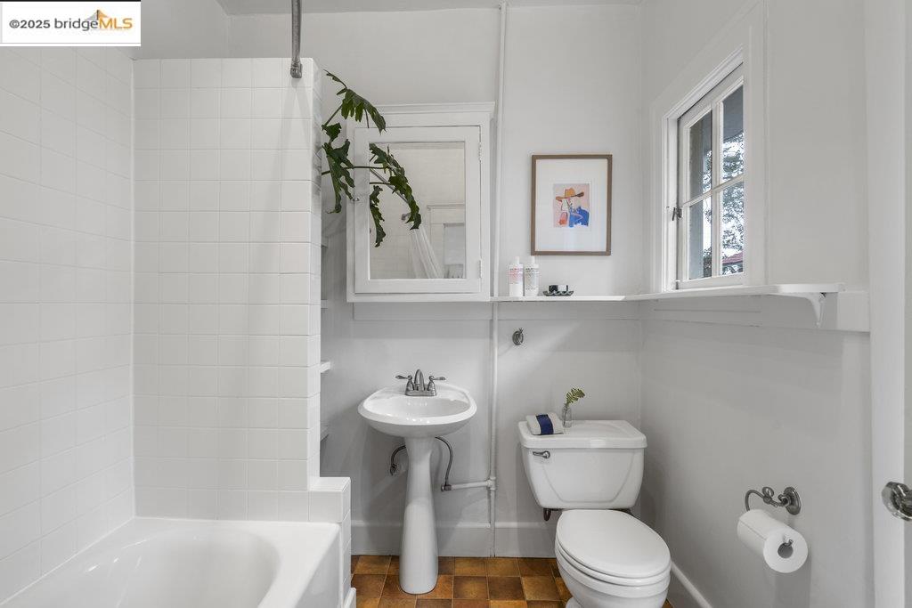 2587 Piedmont Avenue, Unit 3 Berkeley, CA 94704 - Photo 26 of 33 a white toilet sitting next to a bathroom sink and tub