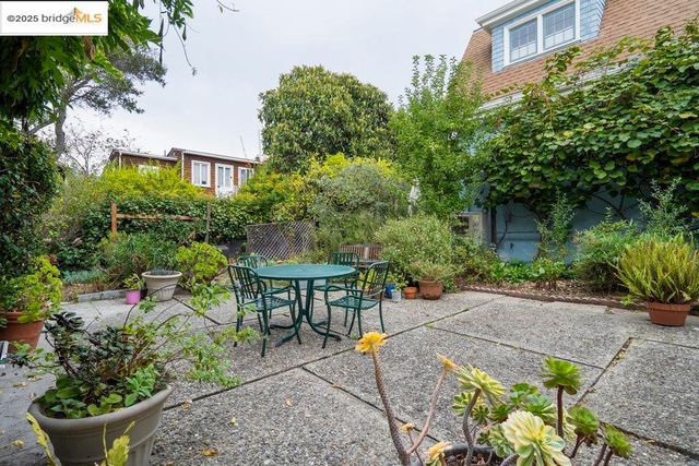 a view of a patio with table and chairs and potted plants