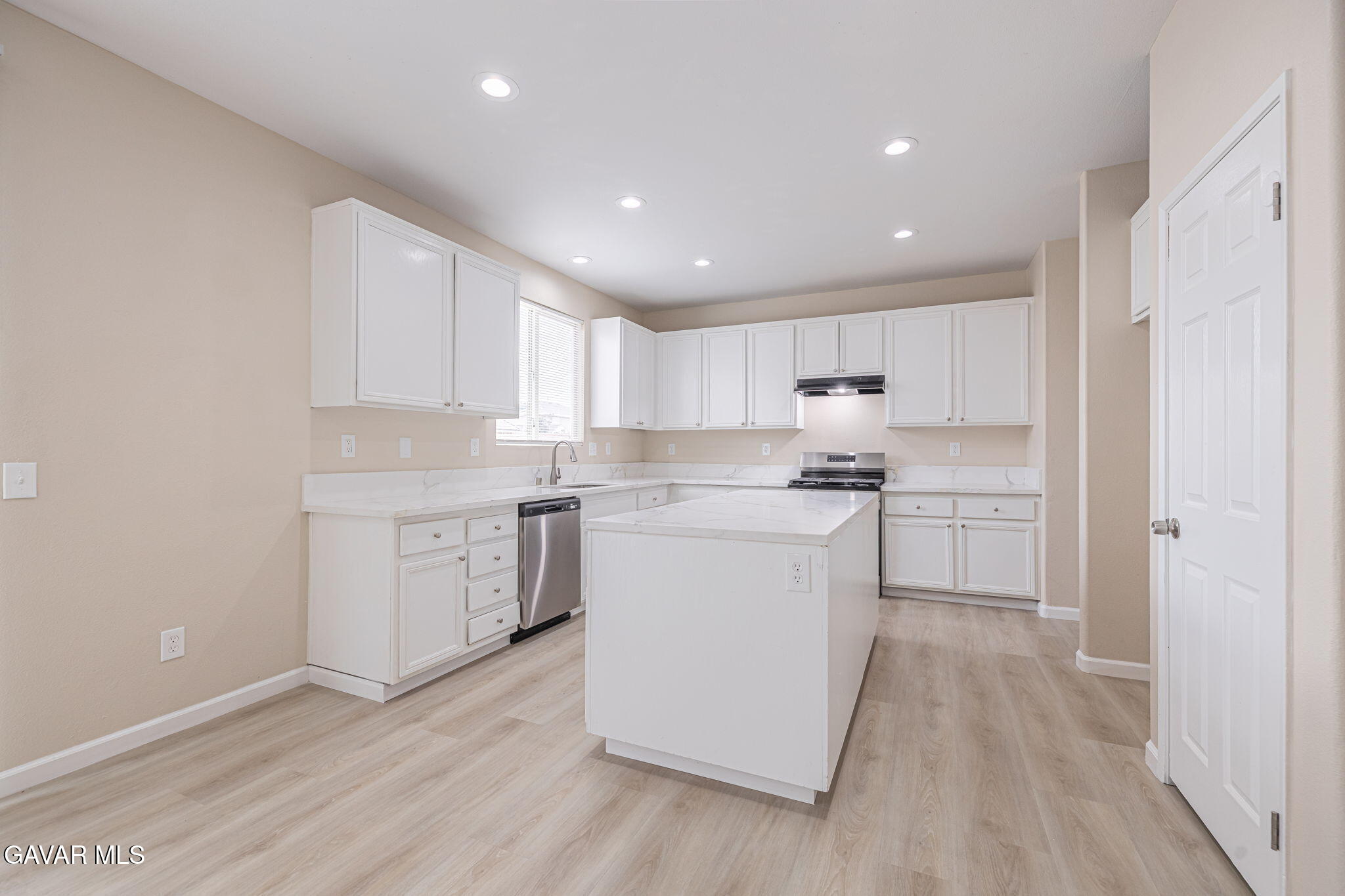 2834 Allessandra Court Lancaster, CA 93535 - Photo 25 of 51 a kitchen with a white wooden cabinets and white stainless steel appliances