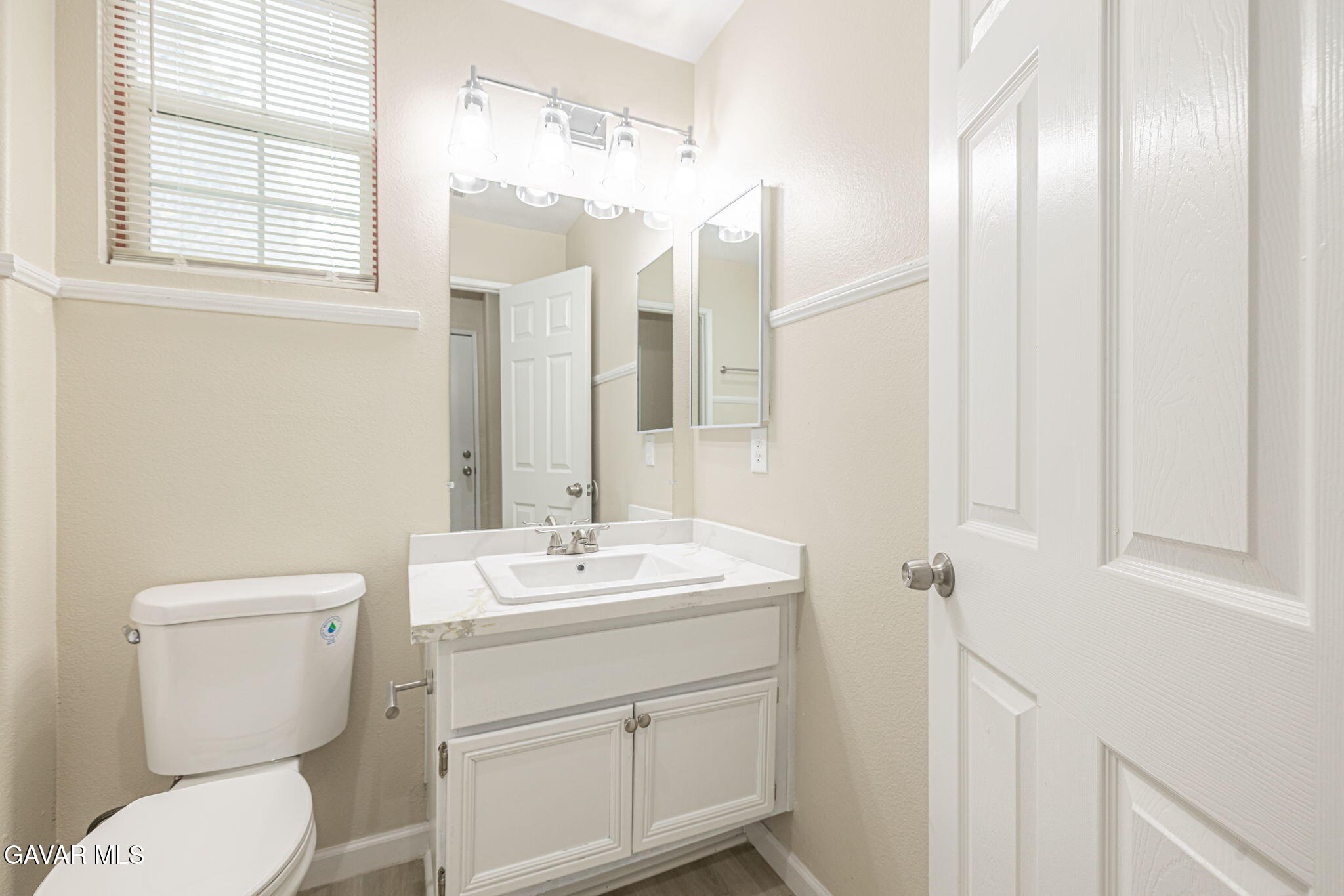 2834 Allessandra Court Lancaster, CA 93535 - Photo 10 of 51 a bathroom with a toilet sink and mirror
