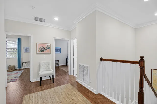 a view of hallway with wooden floor