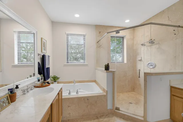 a bathroom with a granite countertop sink mirror and shower