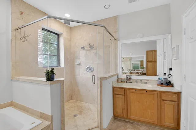 a bathroom with a sink a tub and a mirror