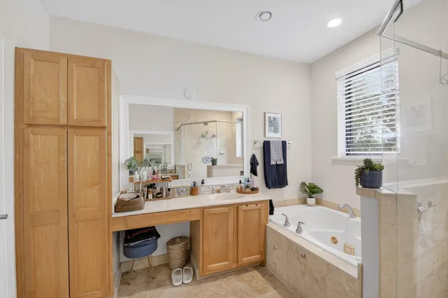 a bedroom with a bed ceiling fan and a window