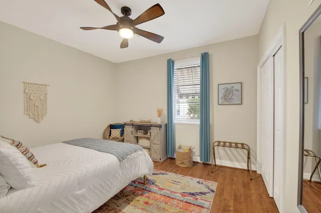 a bedroom with a bed and wooden floor
