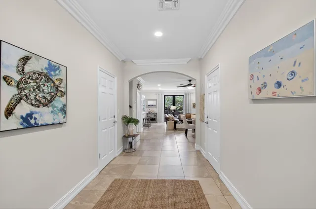 a view of a hallway with wooden floor and furniture