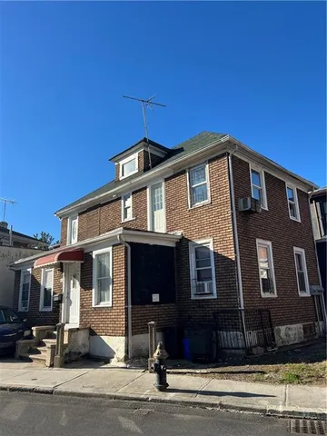 a front view of a house with a street