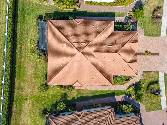 an aerial view of a house with swimming pool and sitting area