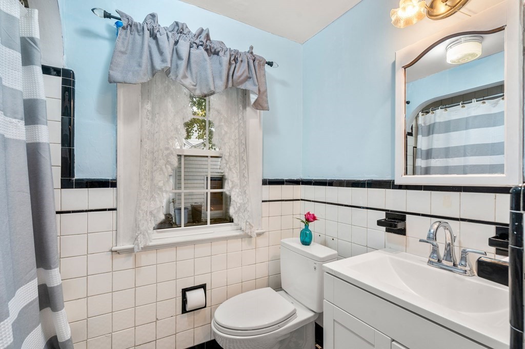 17 Centre Lane Milton, MA 02186 - Photo 12 of 26 a bathroom with a sink vanity mirror and toilet