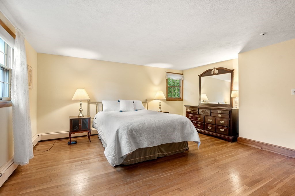 17 Centre Lane Milton, MA 02186 - Photo 14 of 26 a bedroom with a bed and wooden floor