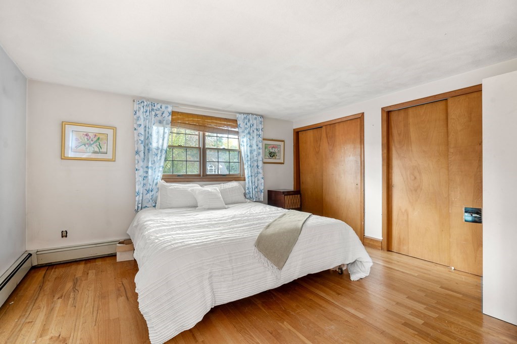 17 Centre Lane Milton, MA 02186 - Photo 16 of 26 a bedroom with a bed and wooden floor