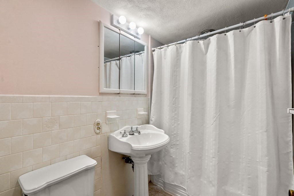 17 Centre Lane Milton, MA 02186 - Photo 19 of 26 a bathroom with a sink toilet and a mirror