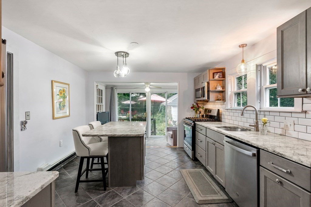 17 Centre Lane Milton, MA 02186 - Photo 8 of 26 a kitchen with stainless steel appliances granite countertop a sink stove and cabinets